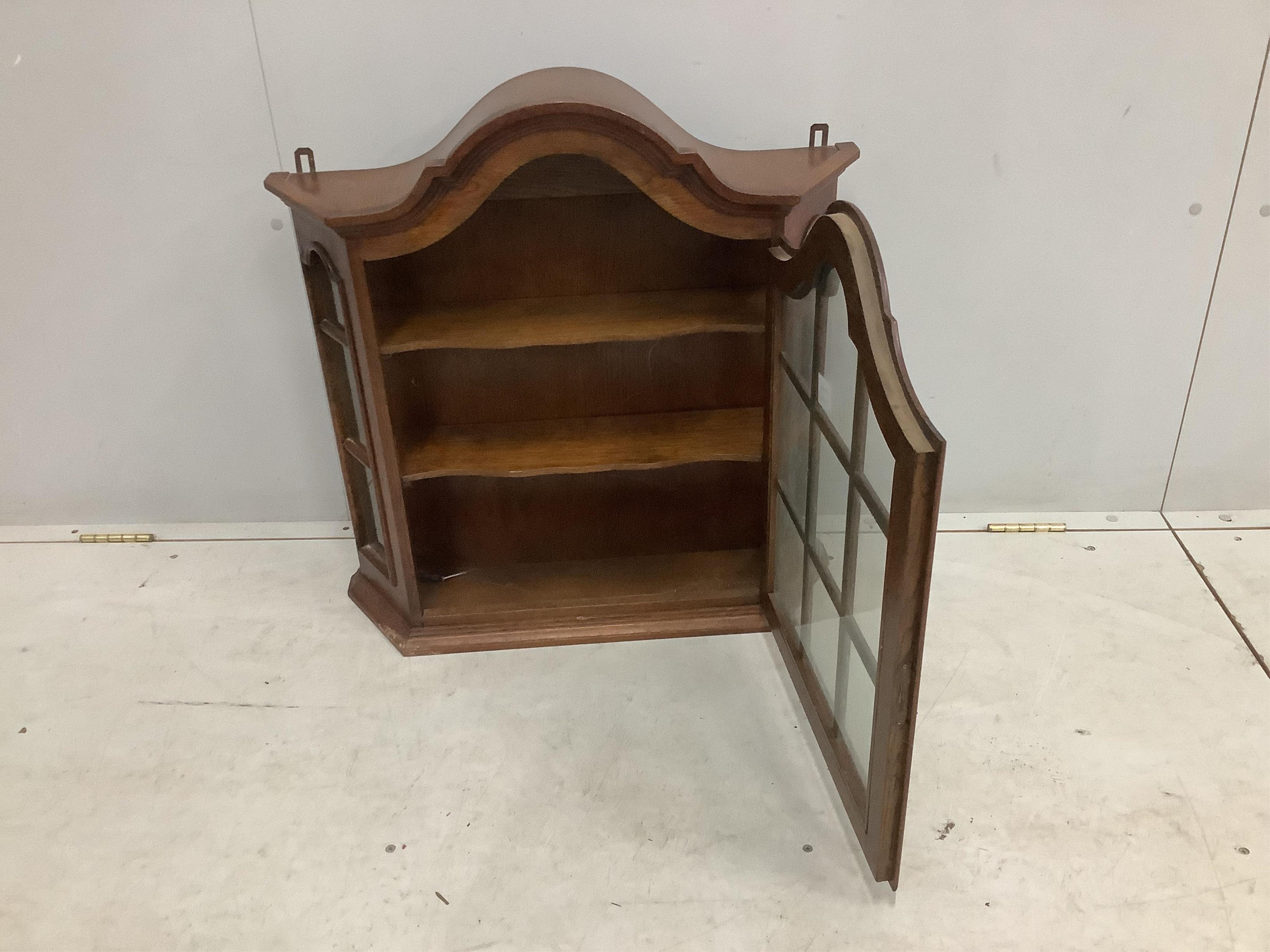 An 18th century style Dutch oak hanging wall cabinet, width 68cm, height 61cm. Condition - good